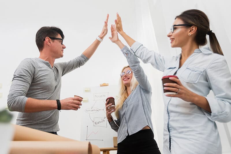 Photo of a business colleagues high fiving